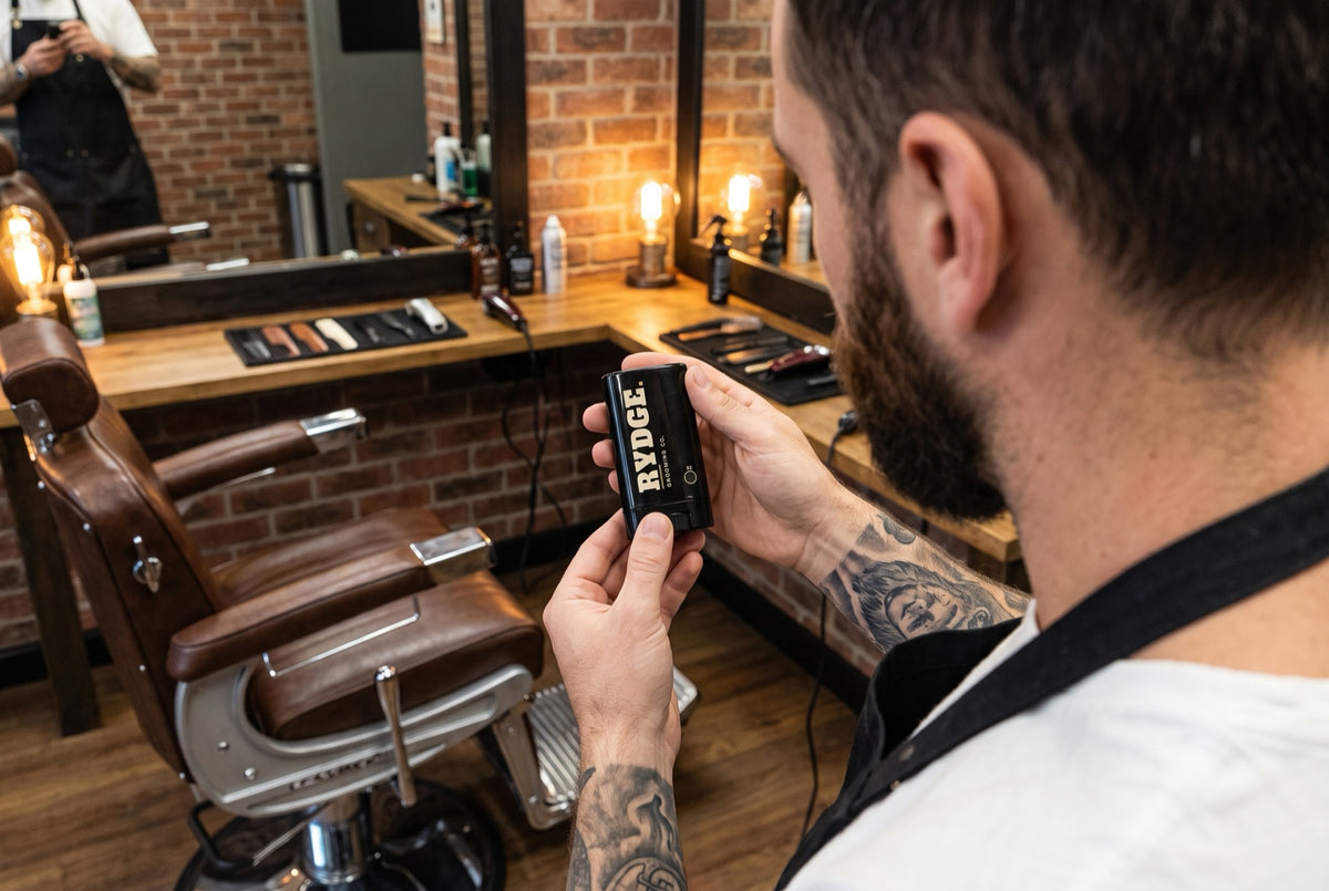 Barber in his shop holding the RYDGE beard stick
