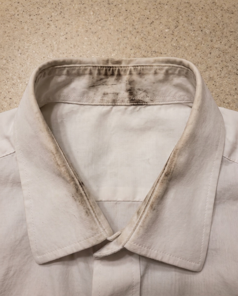 White shirt collar with dark smudges from beard color